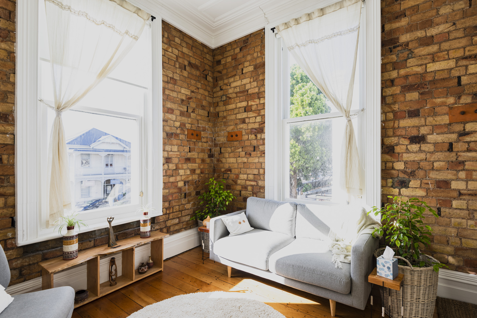 A picture of the coaching space I use with my clients inn Parnell, showing a light, airy room, with a comfy couch and plants.